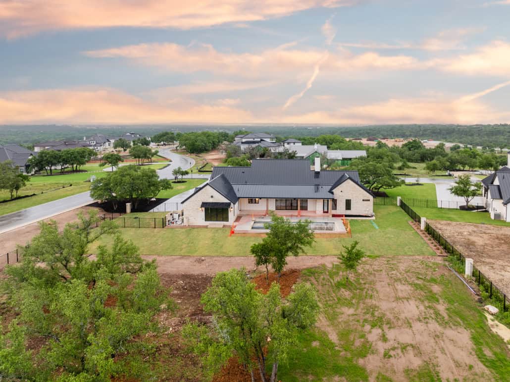 A home with a large yard and a large driveway