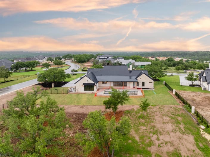 A home with a large yard and a large driveway